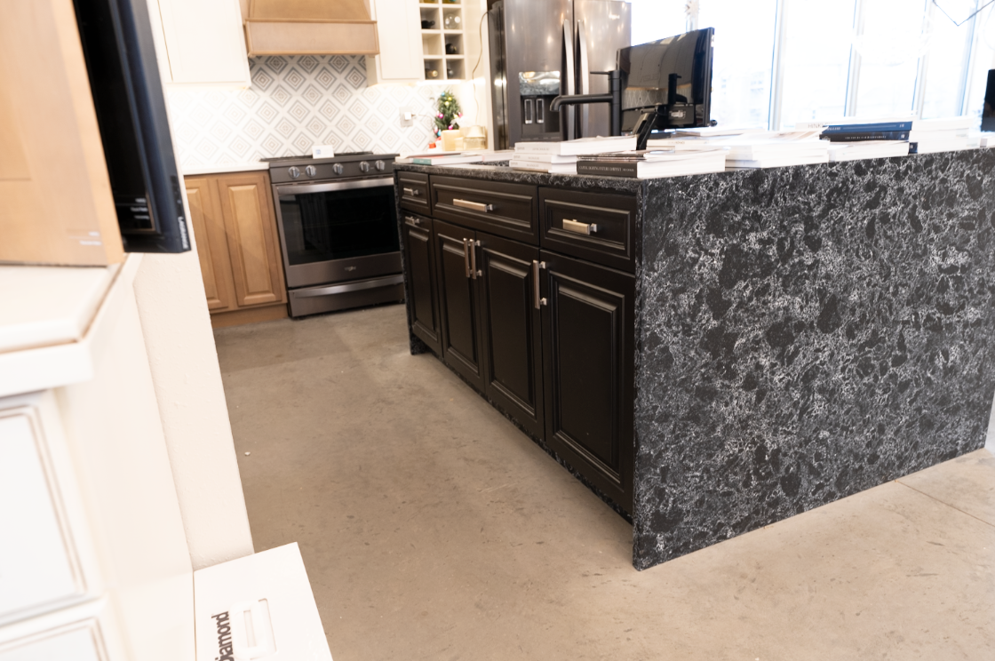 central display showing quartz island with waterfall at showroom in north liberty, iowa
