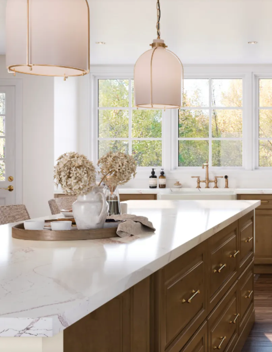 Diamond Cabinetry – Quality and Style for Your Home Bright, inviting kitchen showcasing Diamond cabinetry with warm wood tones, elegant marble countertops, large windows for natural lighting, stylish pendant lights, and tasteful decor accents.