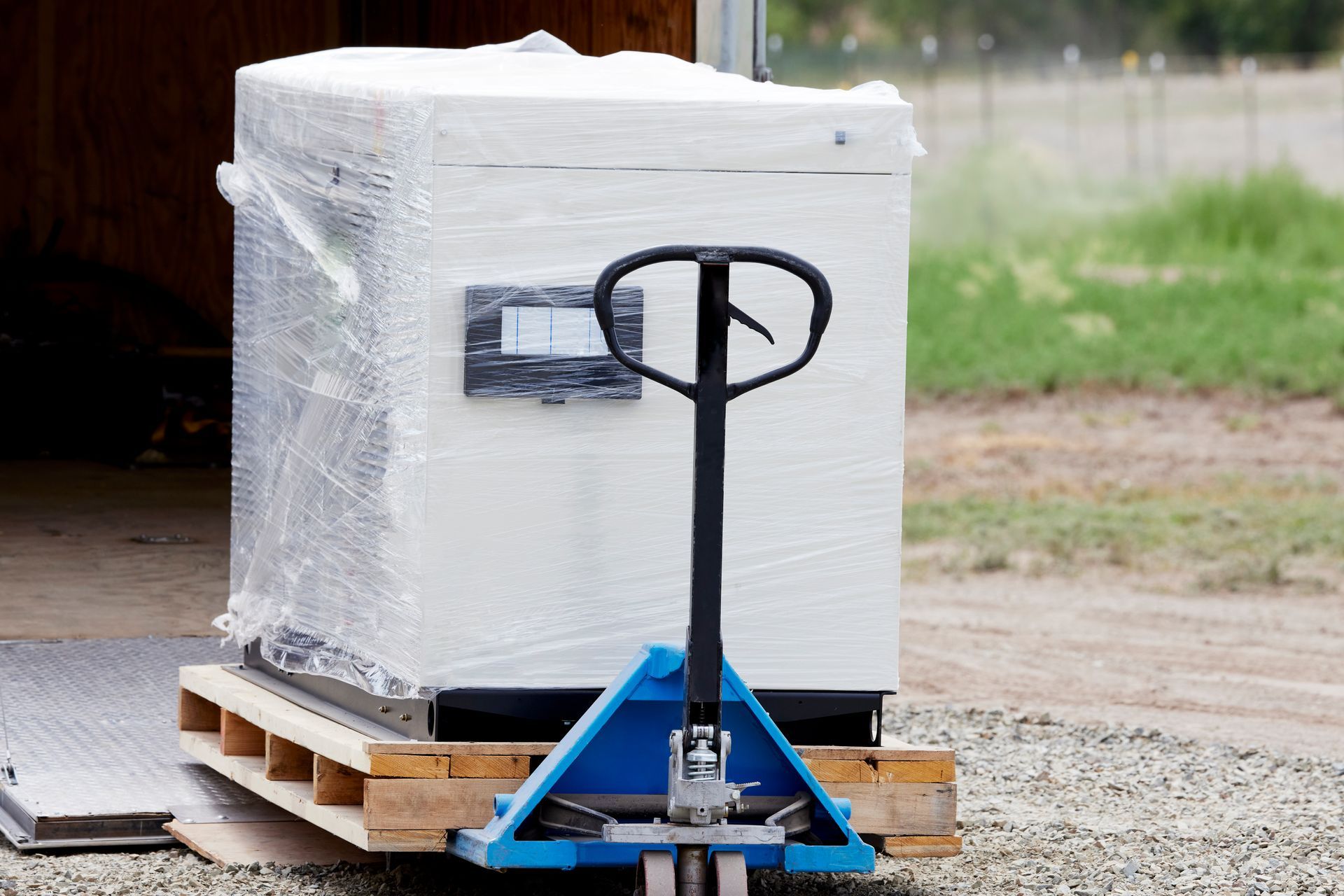 A brand-new residential backup generator being unloaded off a truck for installation at a home