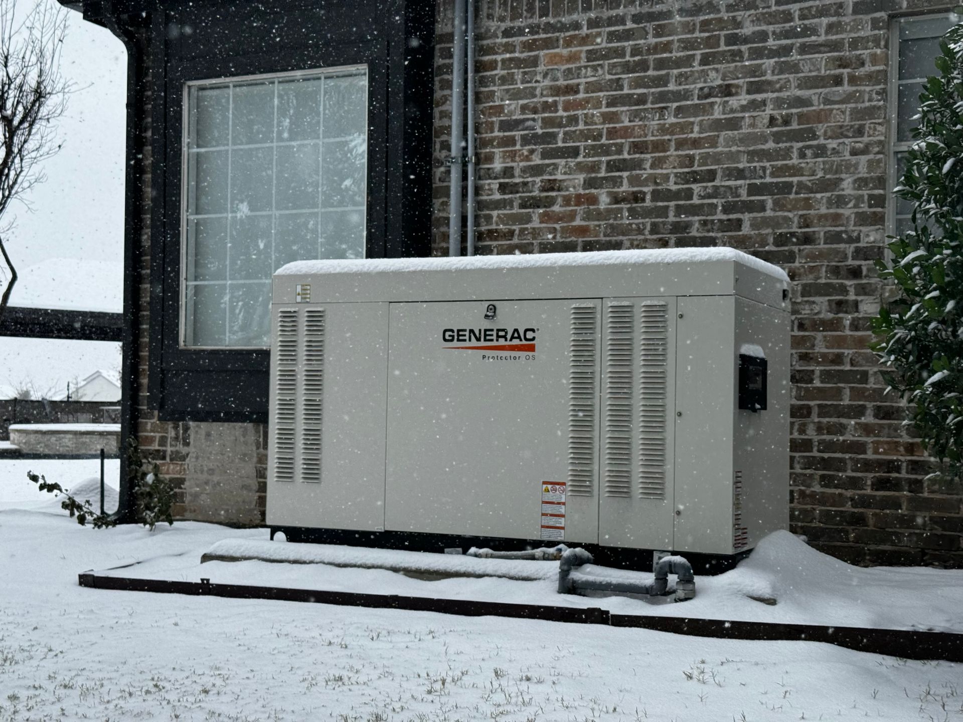 A Generac® generator outside a Texas home in the snow, installed by Premier Generators of Texas