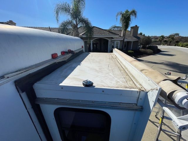 A white van is parked in front of a house