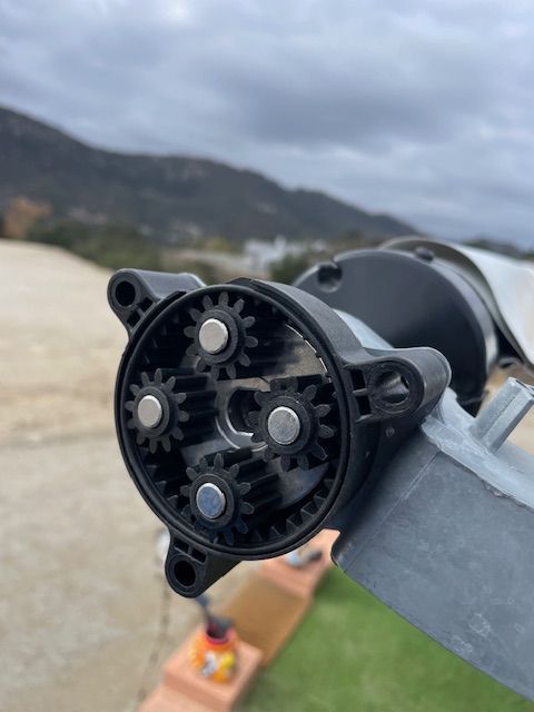A close up of a gear with mountains in the background
