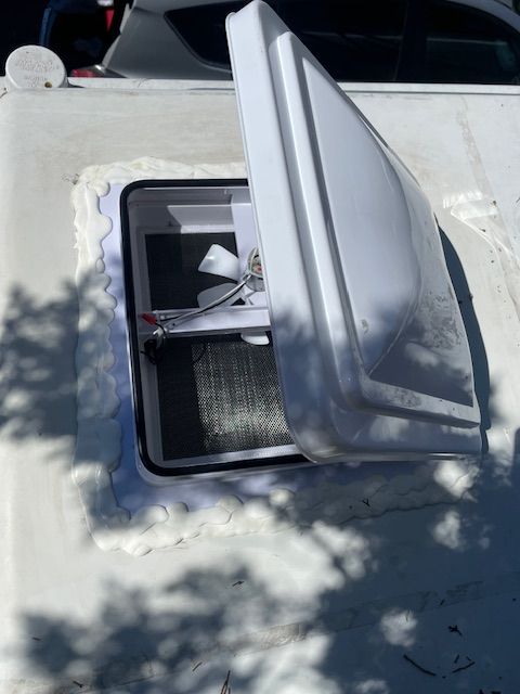 A white roof vent with the lid open