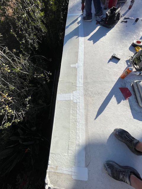 A person is laying on a concrete surface with tape on it.