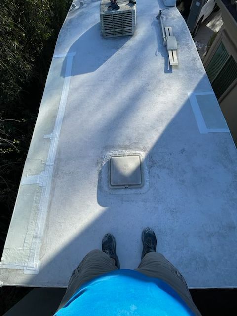 A person standing on top of a white roof