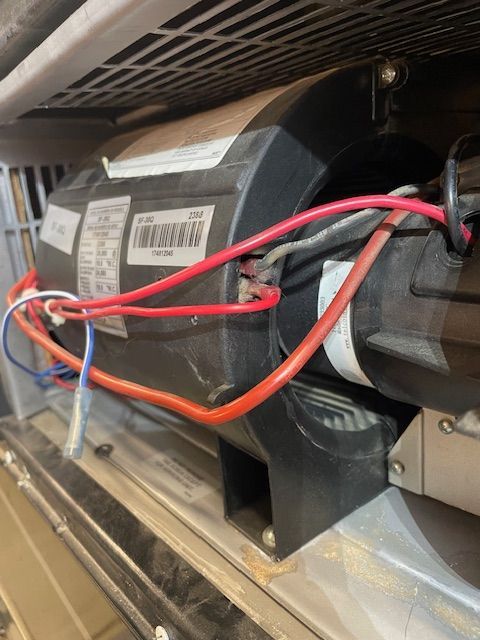 A close up of a motor with wires attached to it