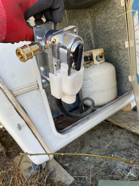 A propane tank is sitting next to a valve