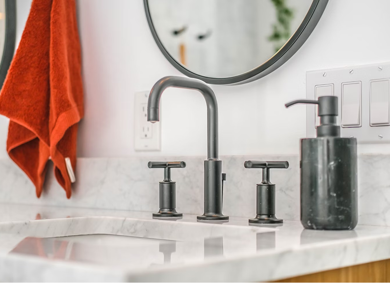 Meeting room with large windows, wooden table, pink chairs, and modern lighting.