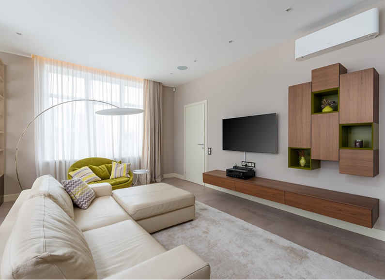 Meeting room with large windows, wooden table, pink chairs, and modern lighting.