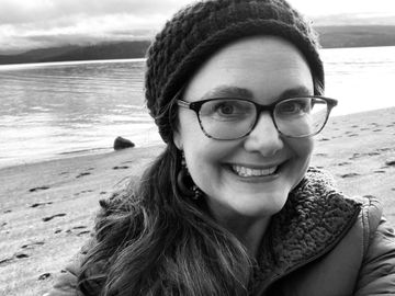 Dana Weir, Clemente Course Director, is smiling in a black and white photo .