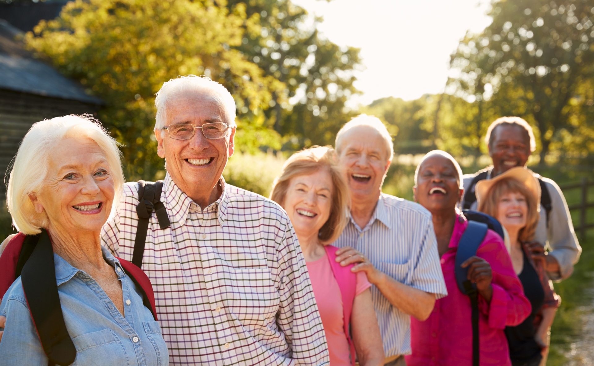 A Group of Elderly People Are Standing in A Line and Smiling.