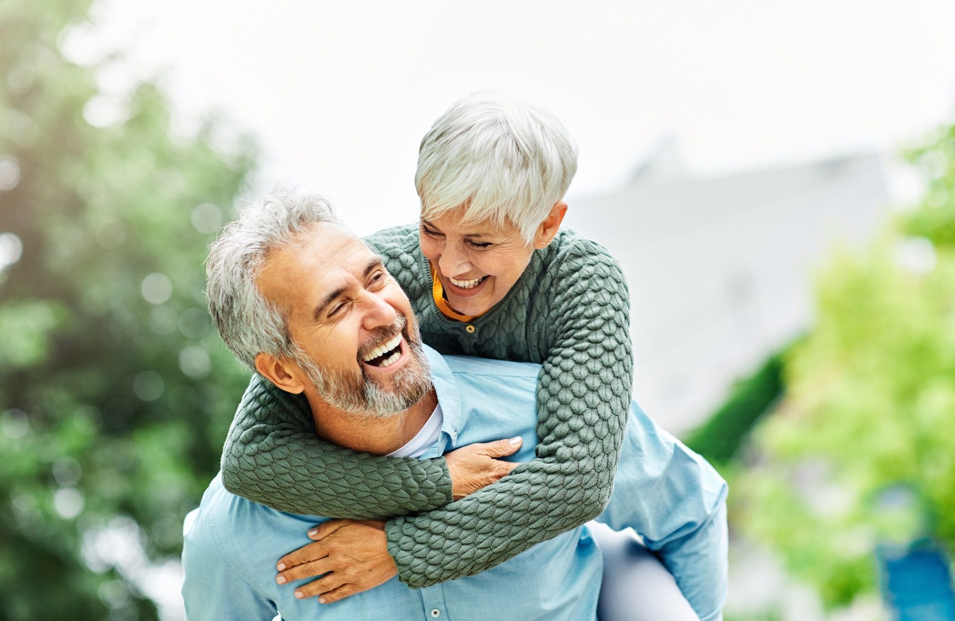 A man is carrying a woman on his back.