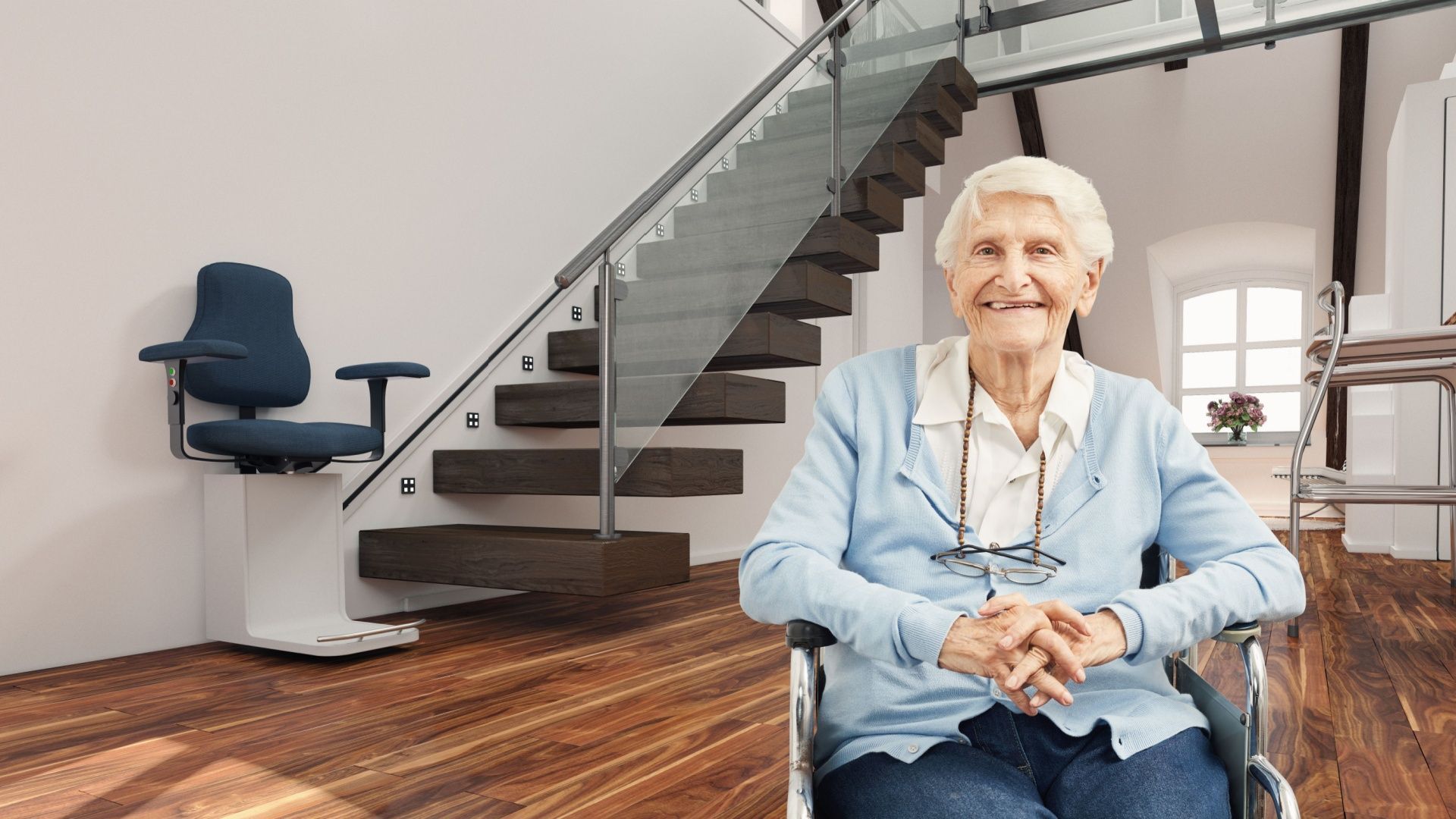 An elderly woman is sitting in a wheelchair in front of a staircase.
