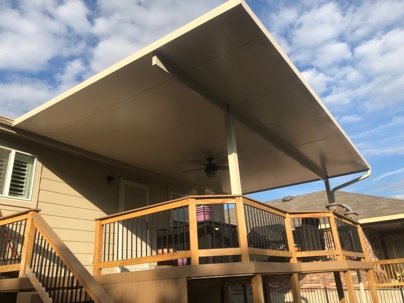 A large deck with a ceiling fan and stairs leading up to it.