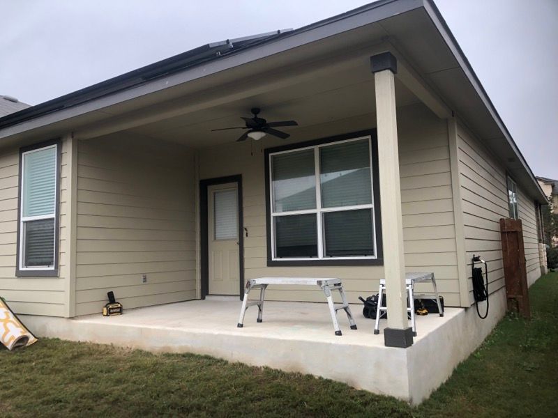 A house with a porch and a ceiling fan