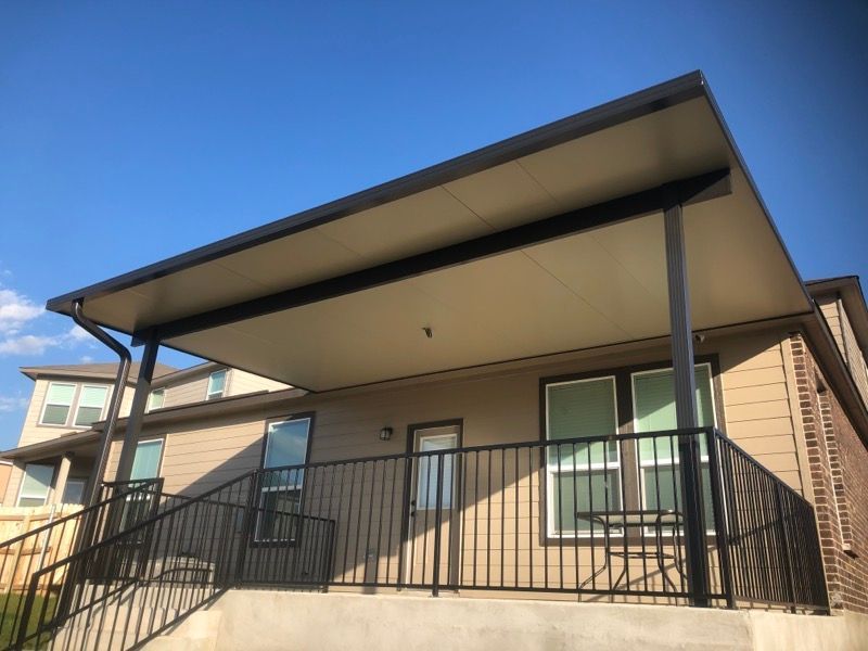 A house with a covered porch and stairs leading up to it.