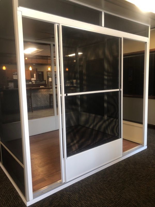 A room with sliding glass doors and a white frame