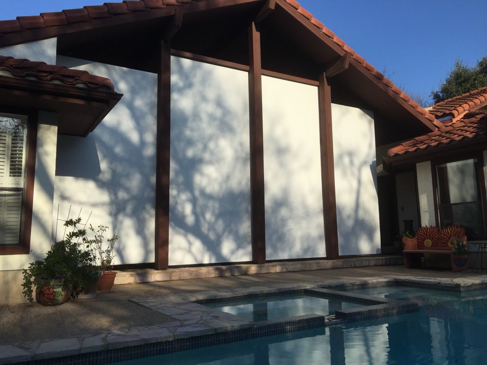 A house with a swimming pool in front of it
