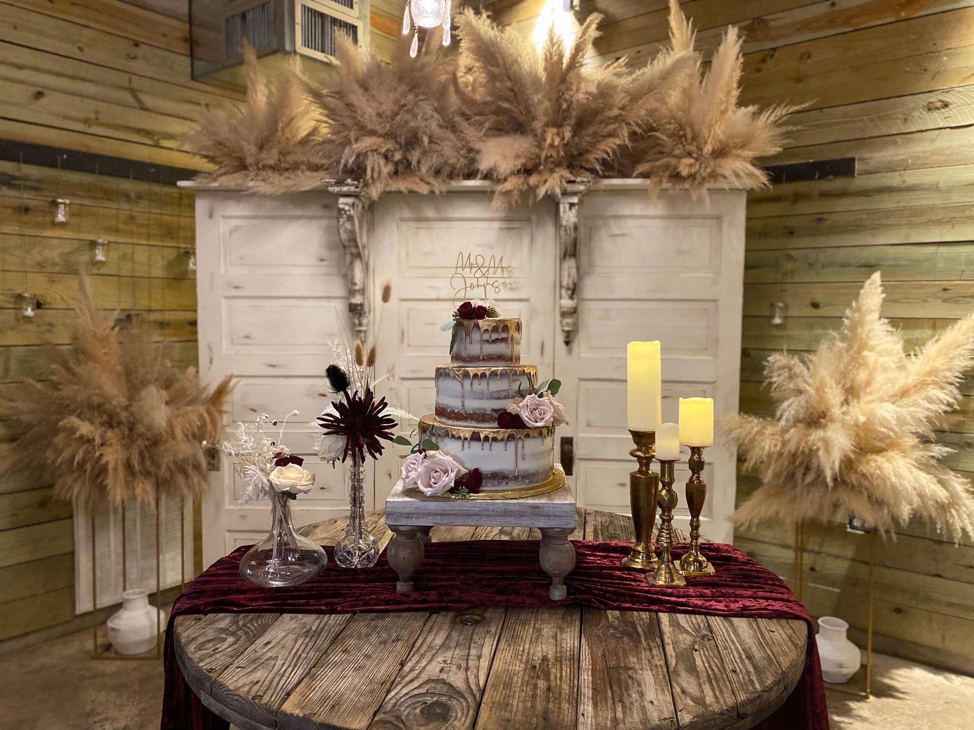 A wooden table with a cake and candles on it.