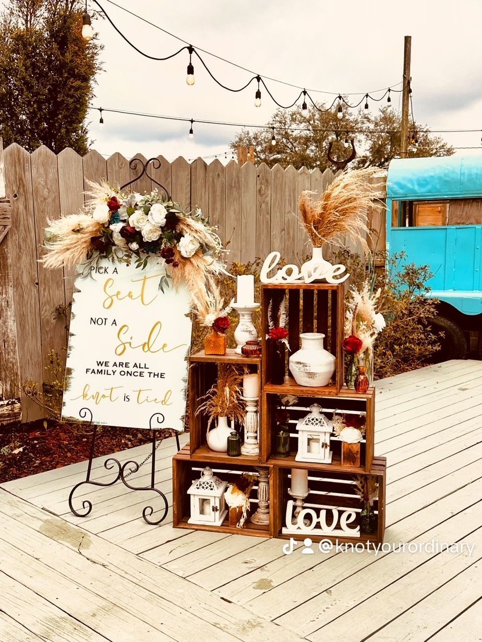 A sign that says `` love '' is sitting on top of a wooden table.