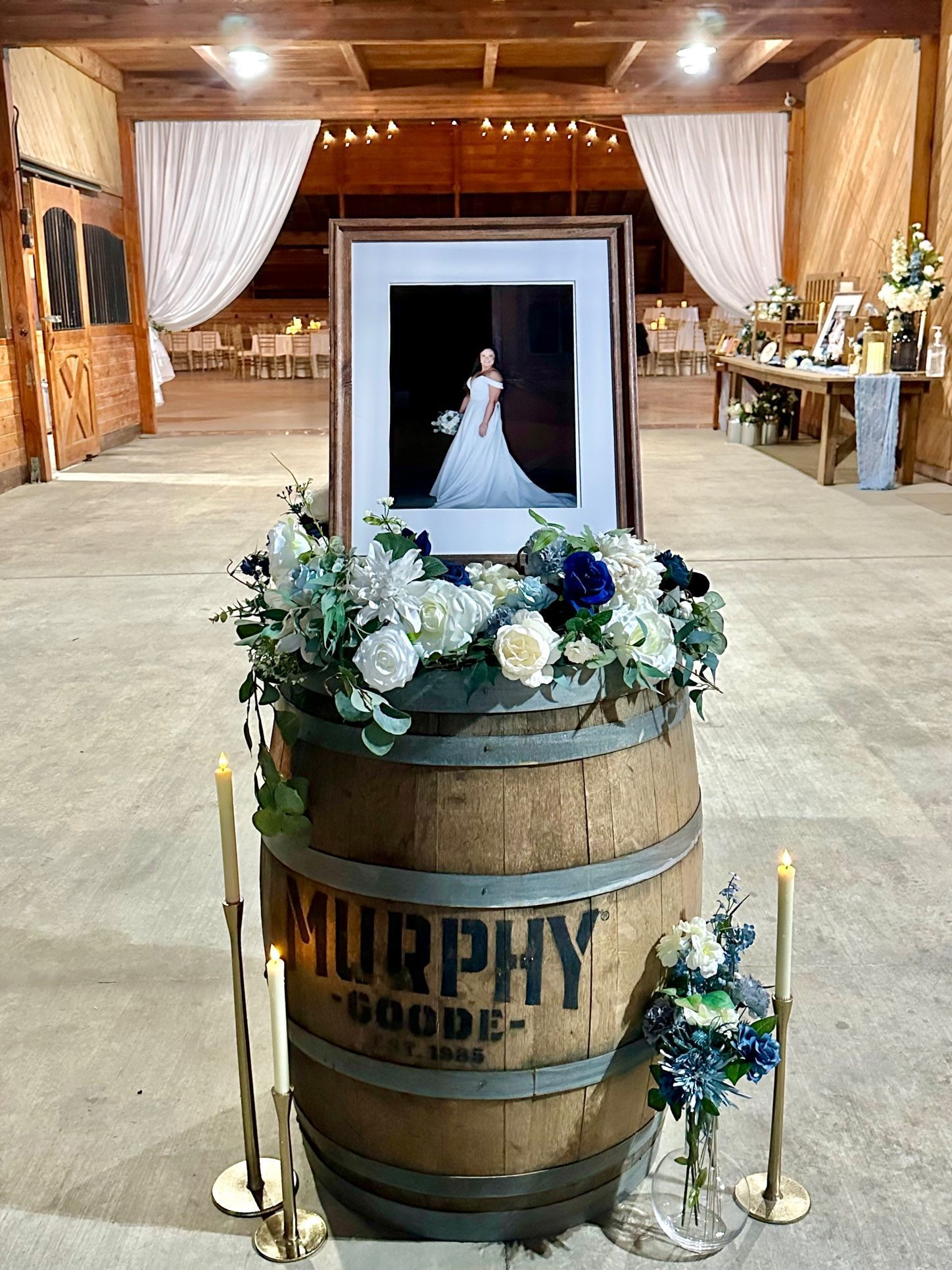 A picture of a bride and groom is sitting on top of a wooden barrel.