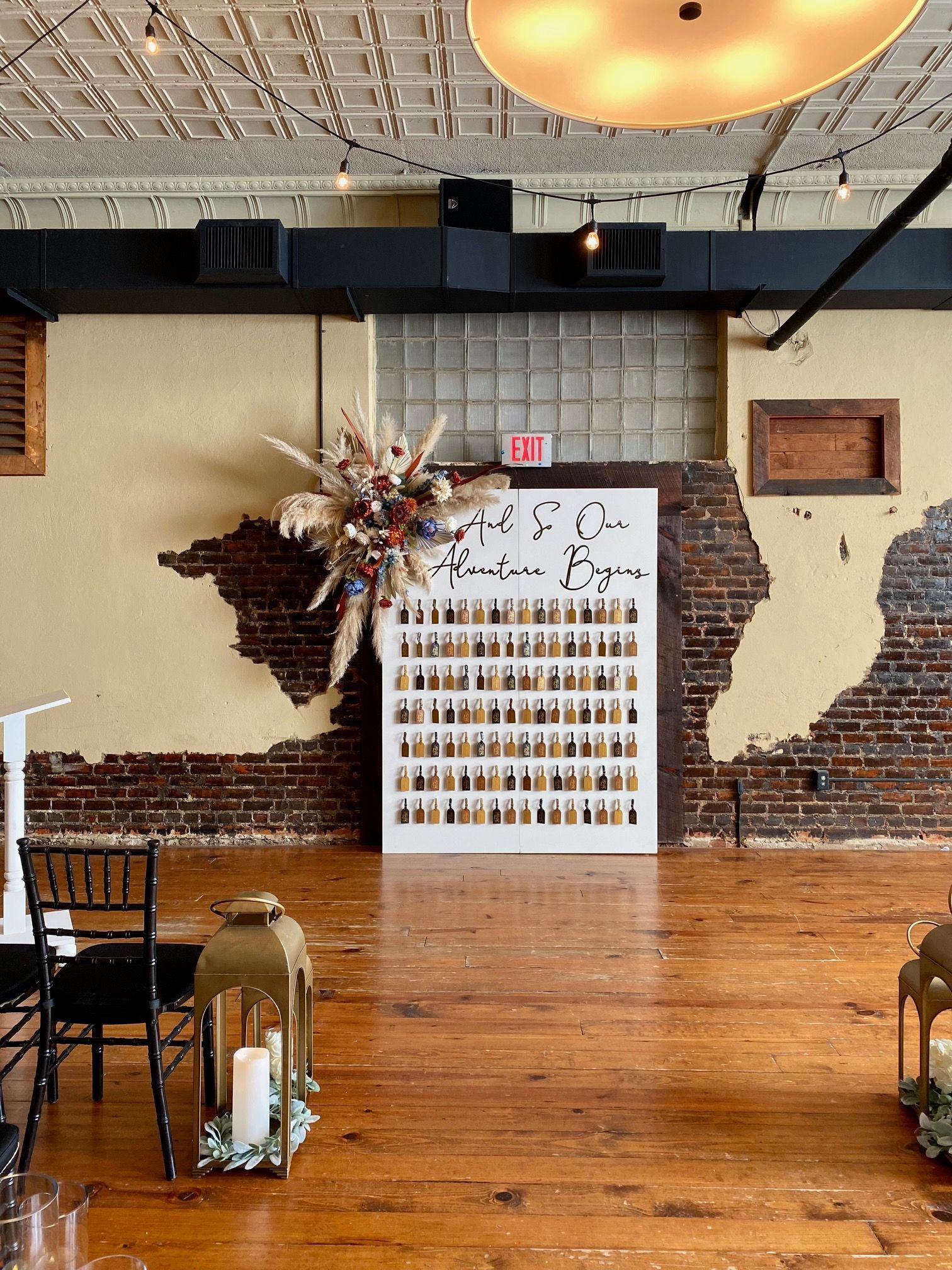 A large room with a wooden floor and a brick wall.