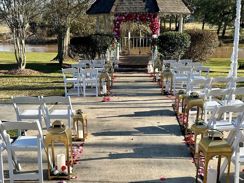 A wedding ceremony is taking place in front of a gazebo.