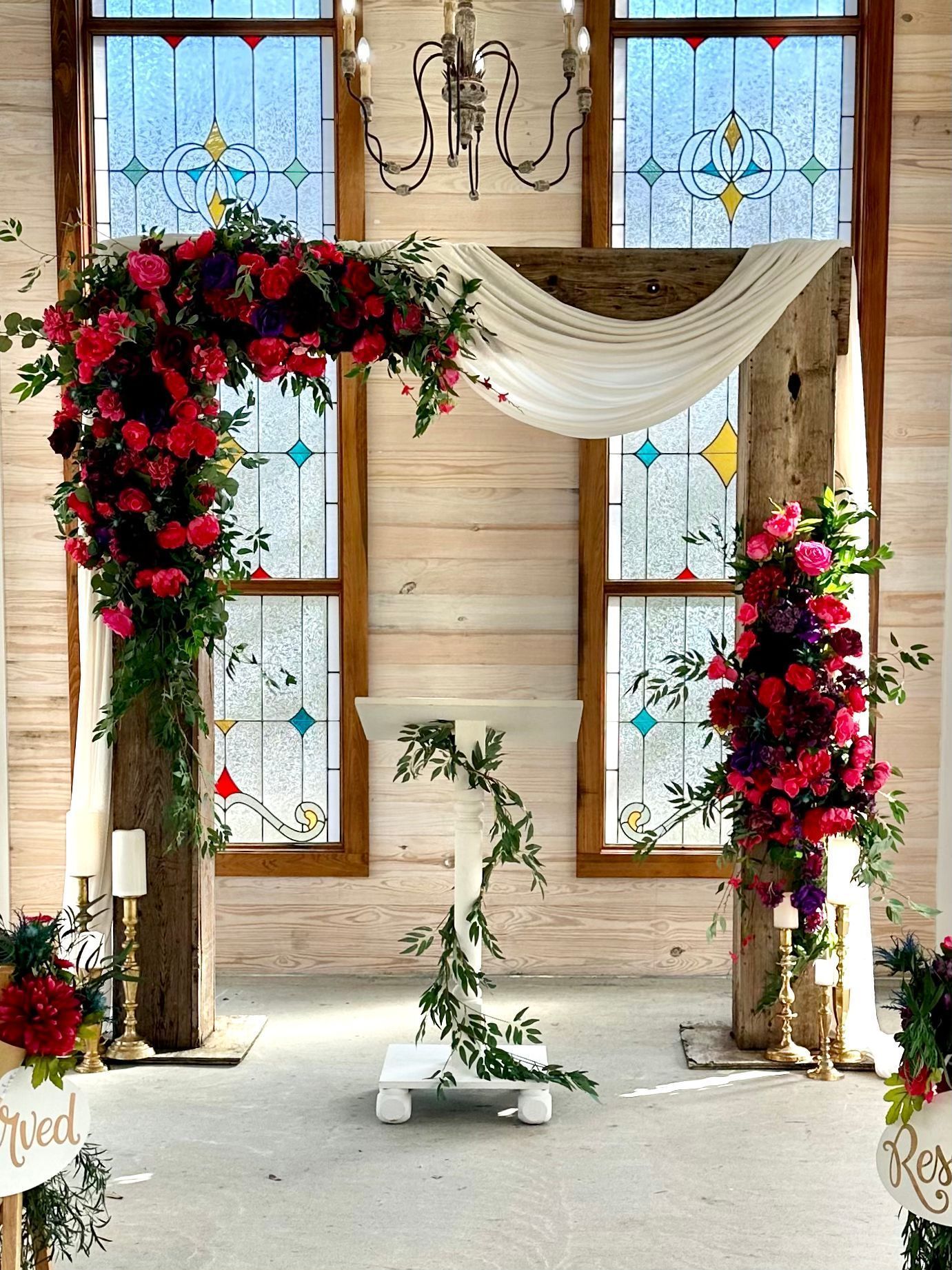 A church decorated with flowers and candles for a wedding ceremony.