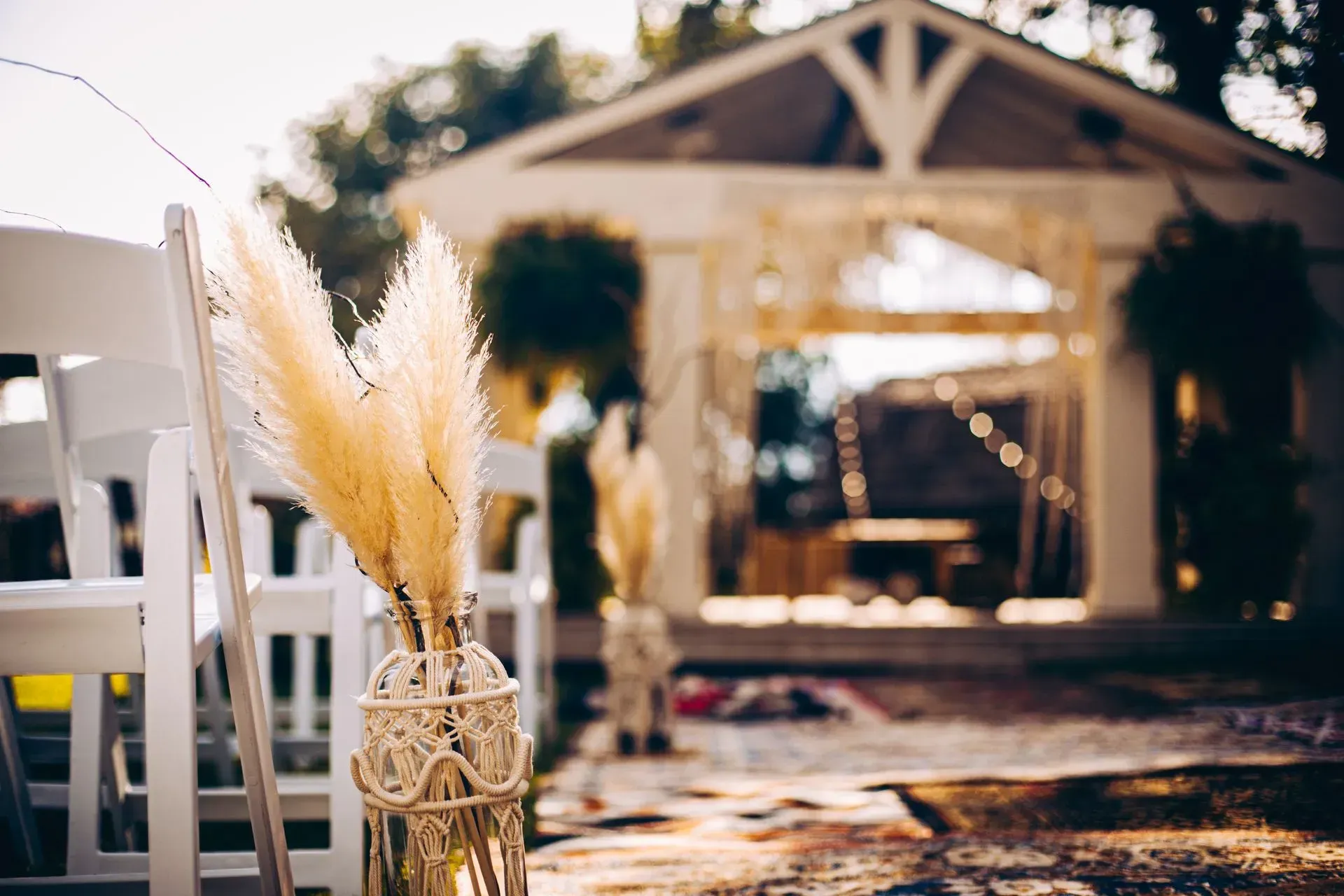 Two vases filled with flowers are sitting on a wooden stump on a table.
