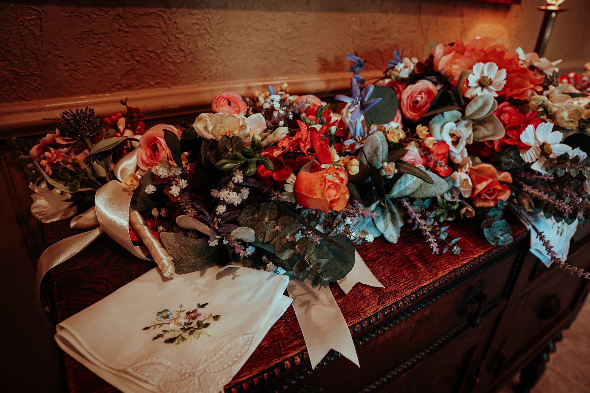 A bunch of flowers are sitting on a table next to a napkin.