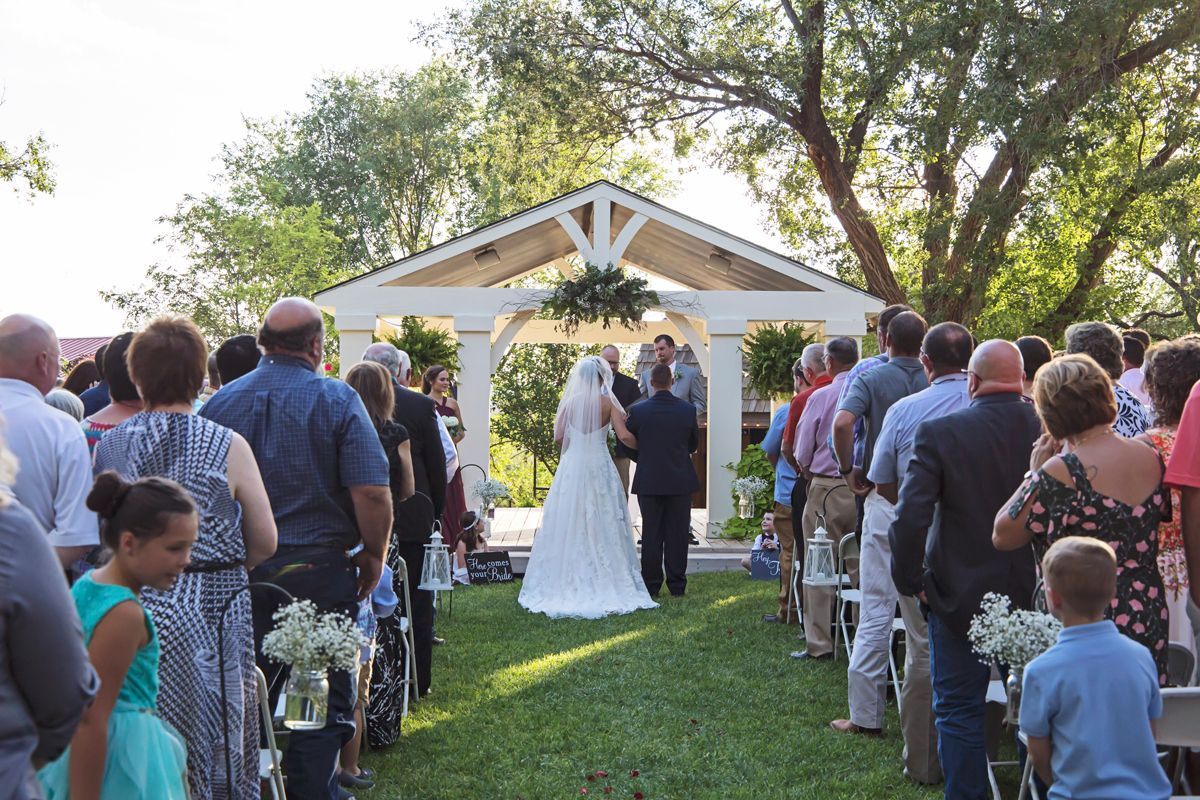 A bride and groom are walking down the aisle at a wedding ceremony.