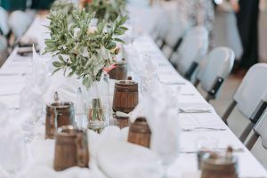 A long table with a vase of flowers on it.