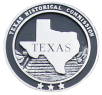 A texas historical commission coin with a map of texas on it.