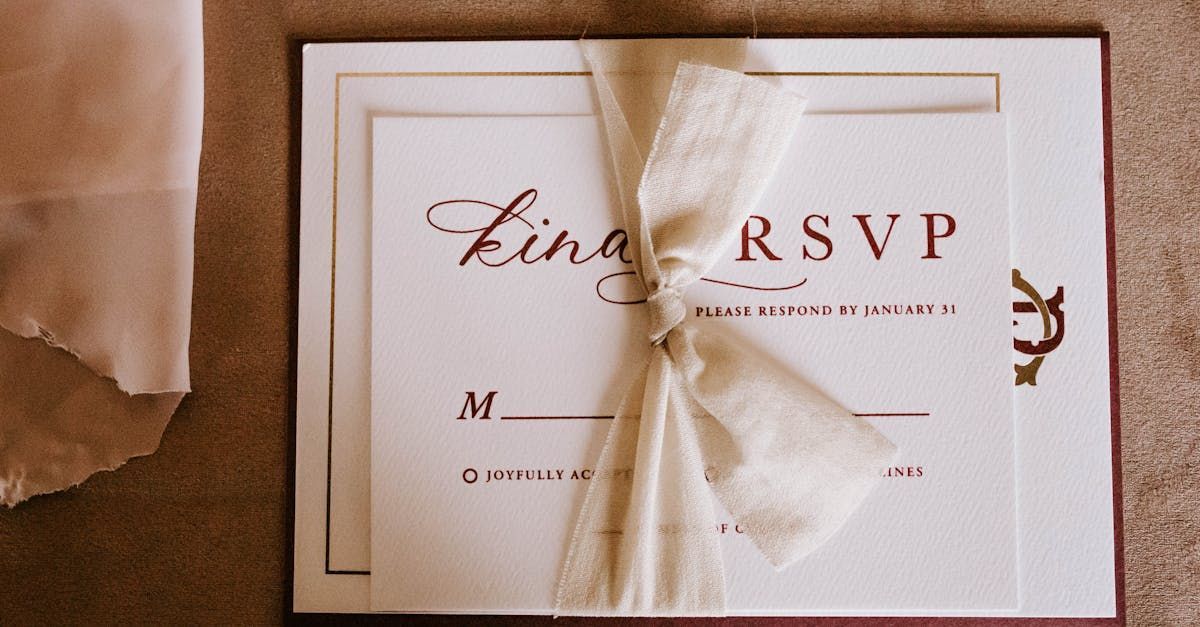 A wedding invitation with a ribbon tied around it is sitting on a table.