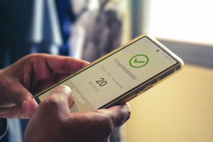 Person holding a gold phone displaying a 