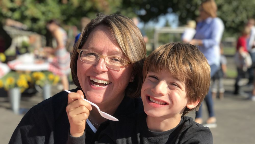 Family with child consults with a lawyer at a table, discussing documents.