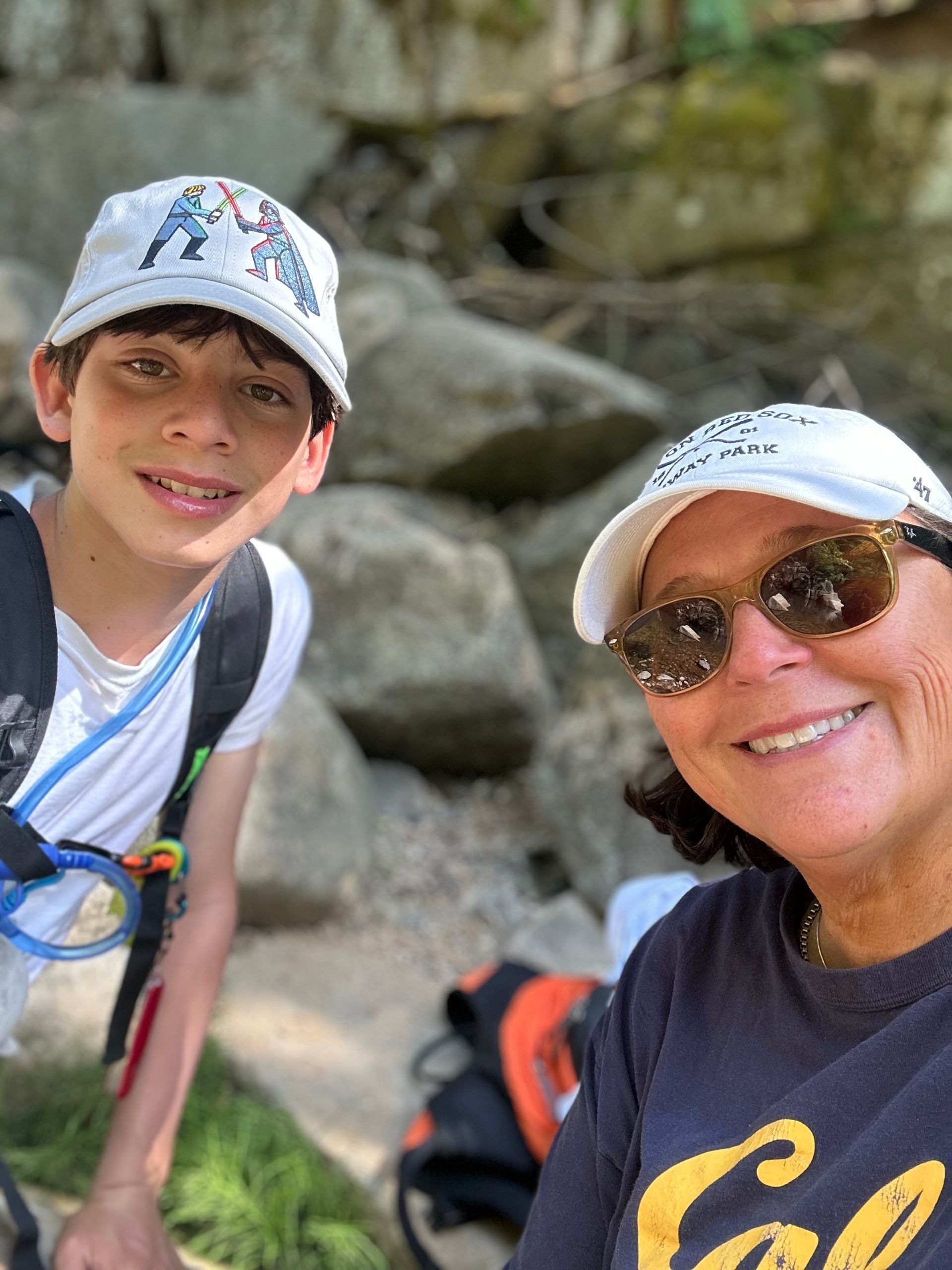 A woman and a boy are posing for a picture together.