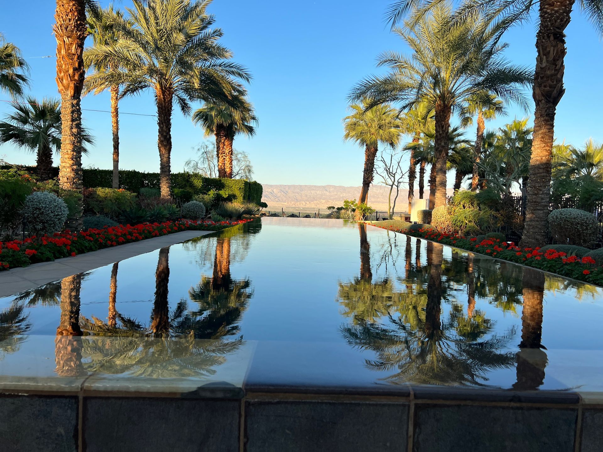 Lawyer signing documents, clients seated, gavel on table.