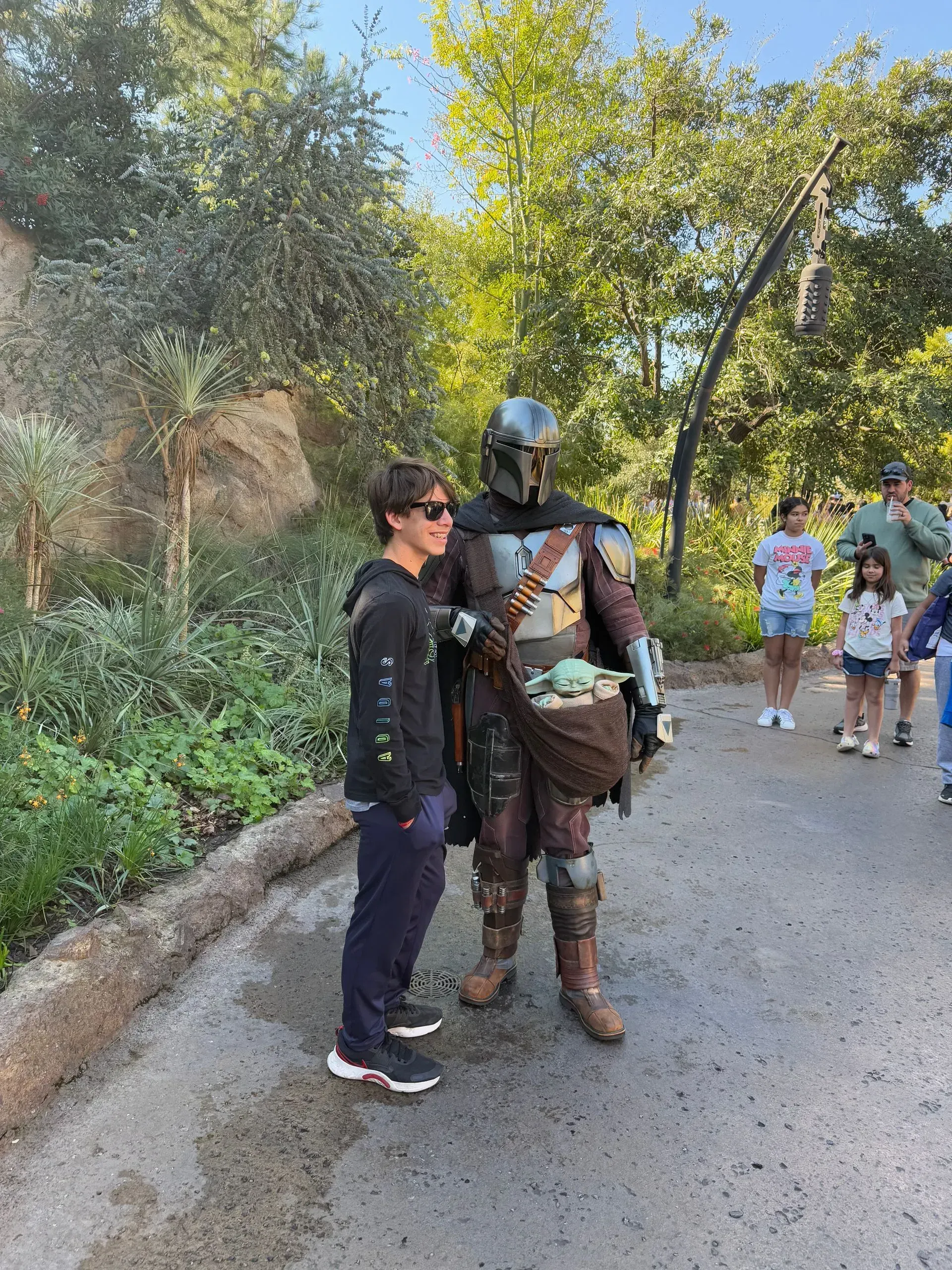 A man in a star wars costume is standing next to a boy.