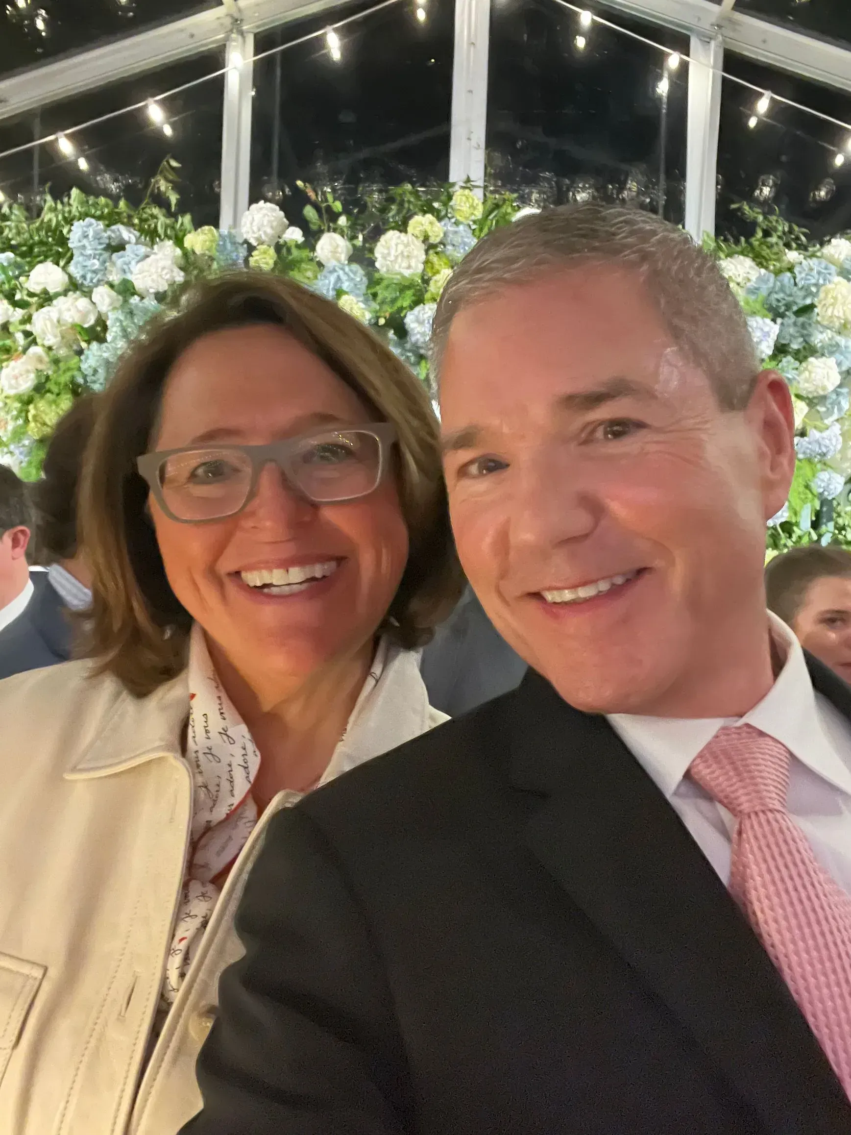 A man and a woman are posing for a picture and smiling