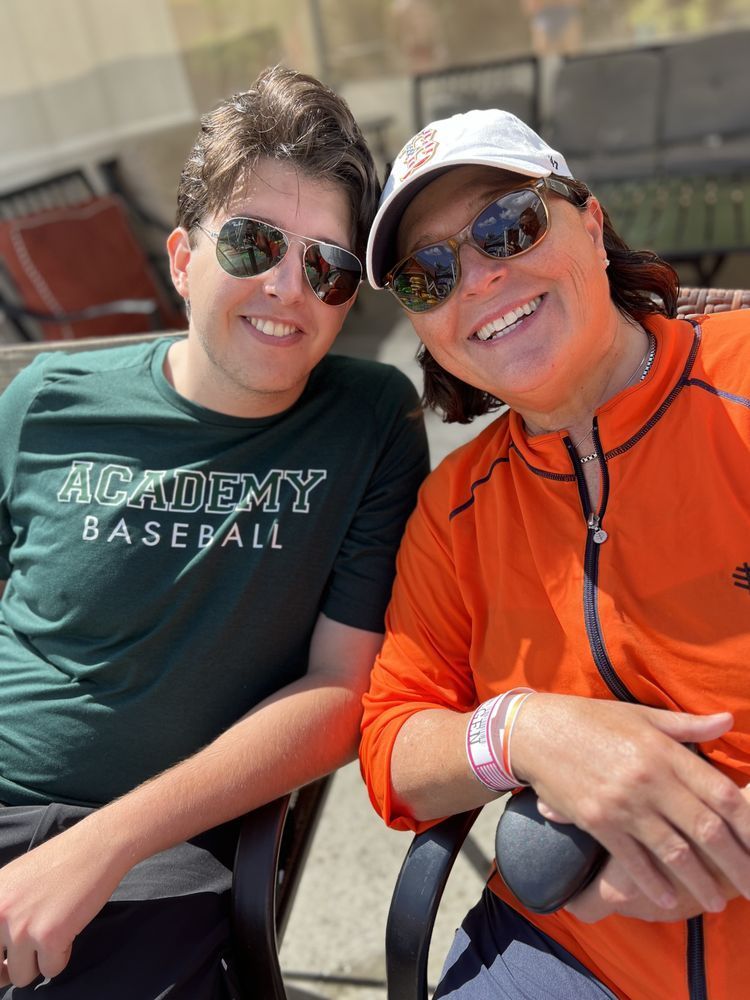 A man and a woman are sitting next to each other and smiling for the camera.