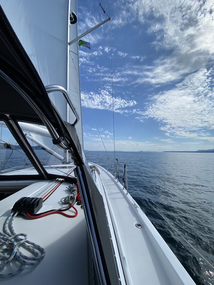 A sailboat is floating on top of a large body of water.