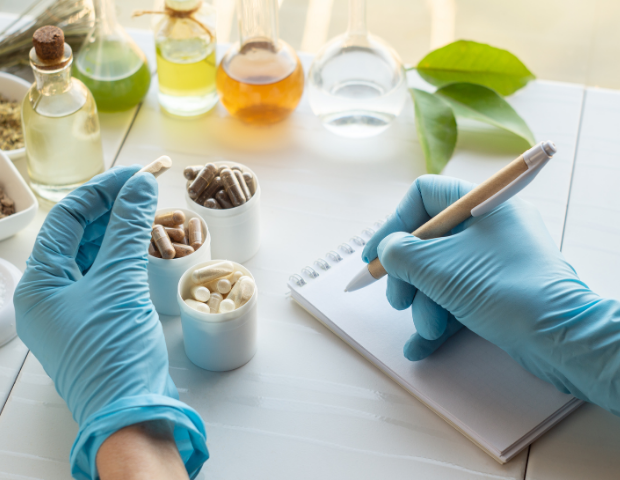Image of a scientist taking notes while working with natural ingredients