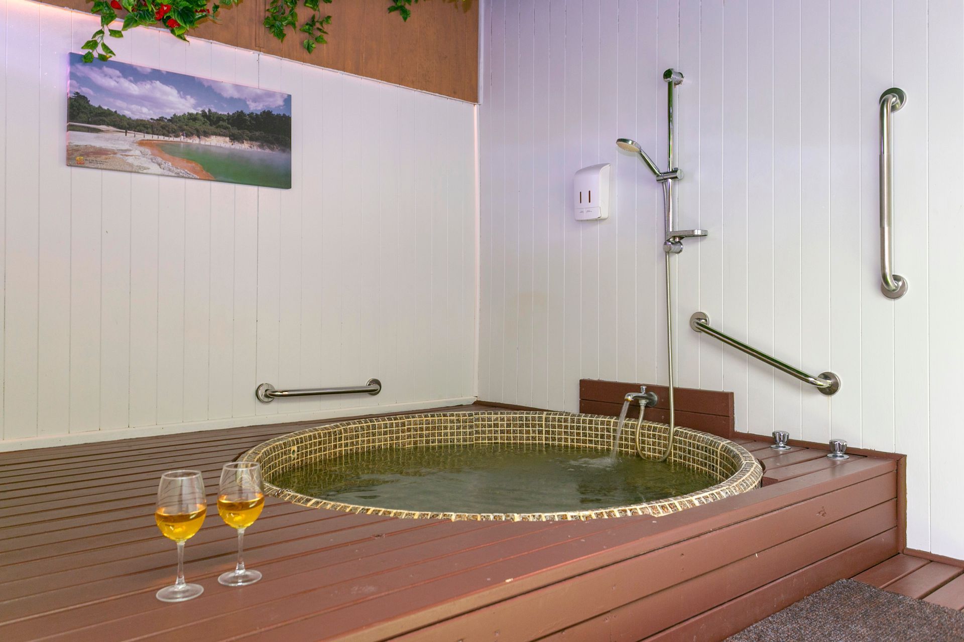 A man and a woman are sitting in a wooden hot tub.
