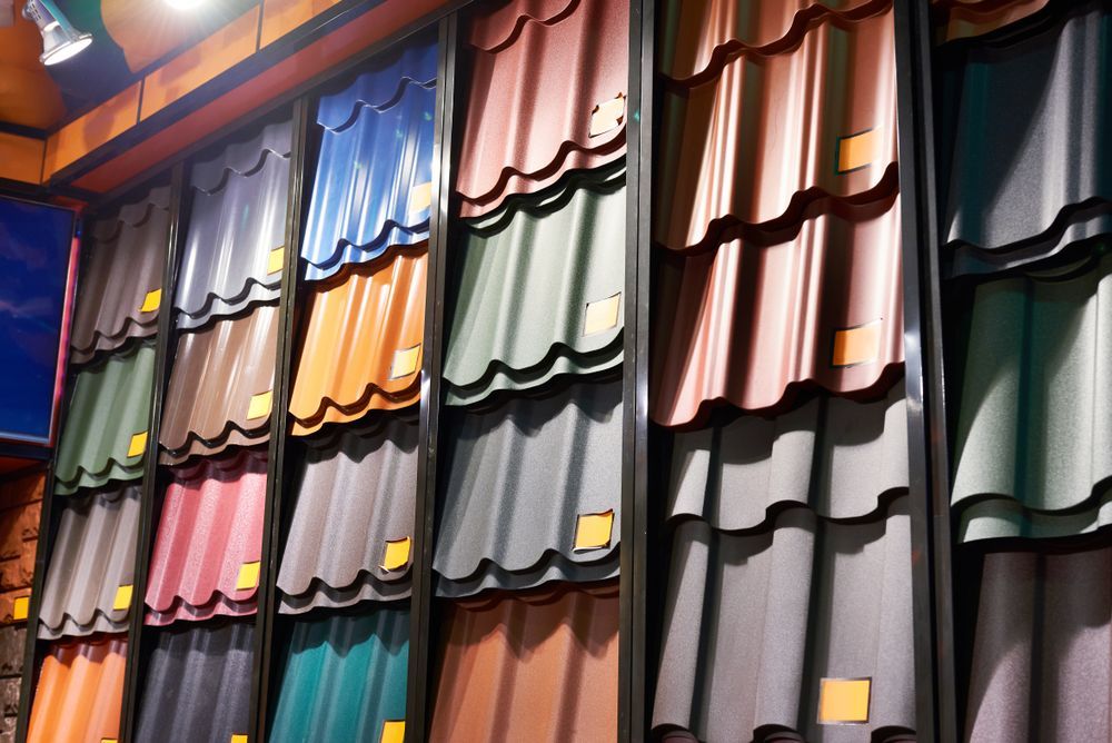 A row of roof tiles of different colours are lined up on a wall — Bradshaw Plumbing & Roofing Pty Ltd In Rural View, QLD