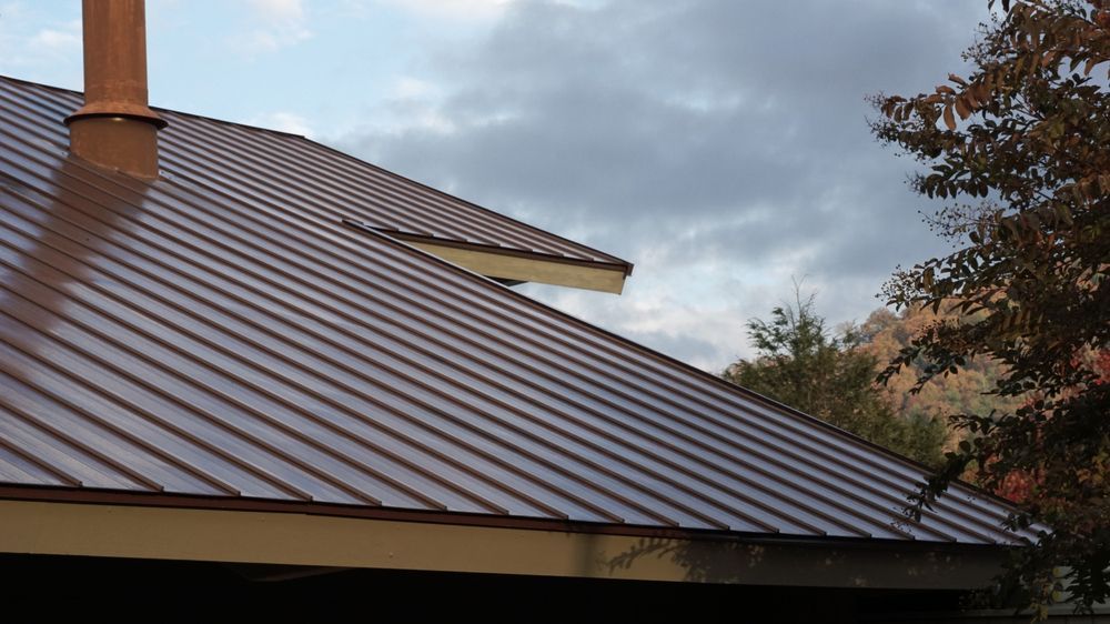 A Brown Metal Roof With a Chimney on Top of It — Bradshaw Plumbing & Roofing Pty Ltd In East Mackay, QLD