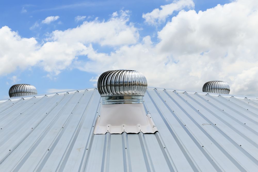 The Roof of a House With a Wind Turbine on It — Bradshaw Plumbing & Roofing Pty Ltd In East Mackay, QLD The Roof of a House With a Wind Turbine on It — Bradshaw Plumbing & Roofing Pty Ltd In East Mackay, QLD