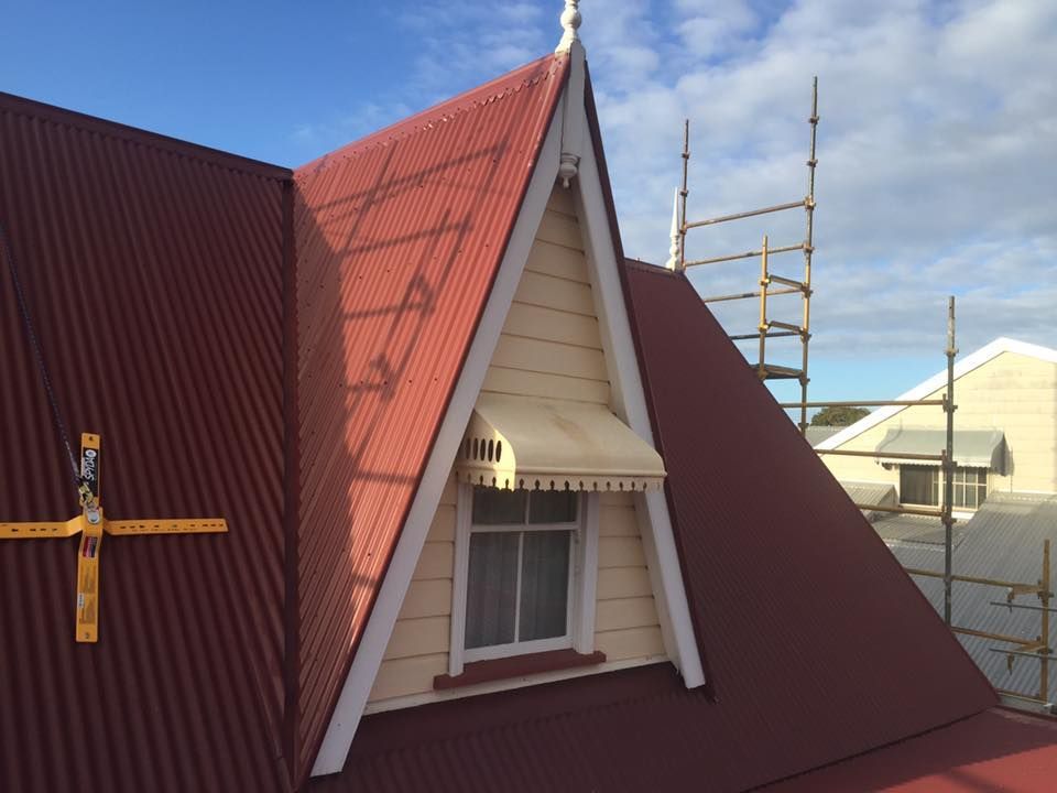 A Red Roof With a White Awning on It — Bradshaw Plumbing & Roofing Pty Ltd In East Mackay, QLD