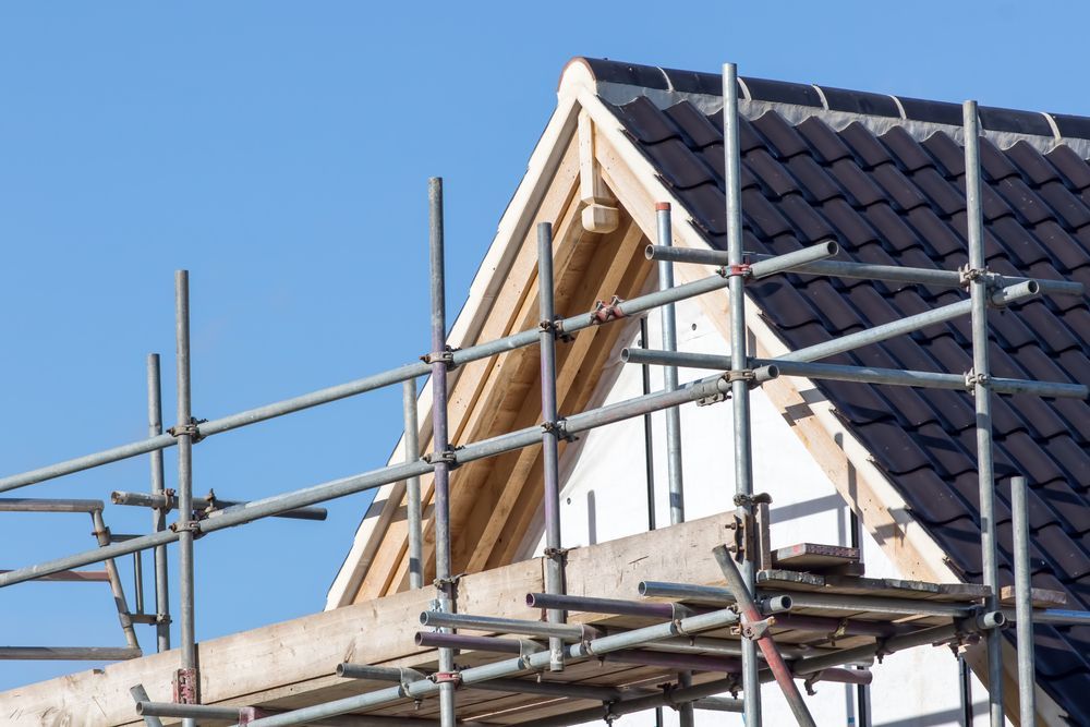 A House is Being Built With Scaffolding on the Side of It — Bradshaw Plumbing & Roofing Pty Ltd In Paget, QLD A House is Being Built With Scaffolding on the Side of It — Bradshaw Plumbing & Roofing Pty Ltd In Paget, QLD
