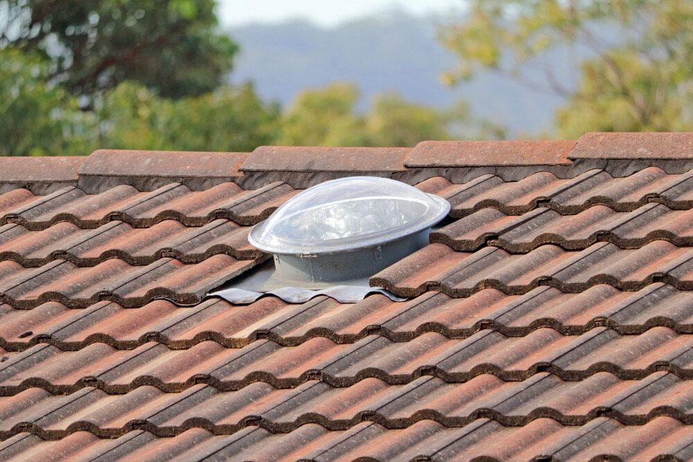 A Roof With a Skylight in the Middle of It — Bradshaw Plumbing & Roofing Pty Ltd In Paget, QLD A Roof With a Skylight in the Middle of It — Bradshaw Plumbing & Roofing Pty Ltd In Paget, QLD